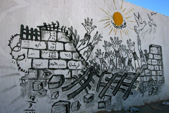 //Hands breaking free from chains, birds flying towards the sky, graffitied graffiti. A symbolic mural from Tripoli.