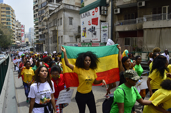 //Ethiopian migrant workers hold up the Ethiopian flag at the annual Migrant Workers' March in Beirut (Anti-Racism Movement)