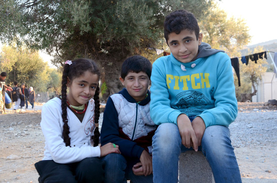 //Stopping on Lesbos on the way to Germany, Yaza (right, with his younger siblings Aya and Yamen) says, “I just hope I’m treated like a human being.”