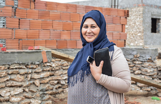 //Devant sa future maison, Leila sourit en imaginant déjà le résultat final.